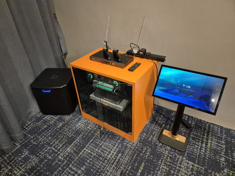 Mobile entertainment unit with wireless microphone receivers, a compact subwoofer and a touchscreen display