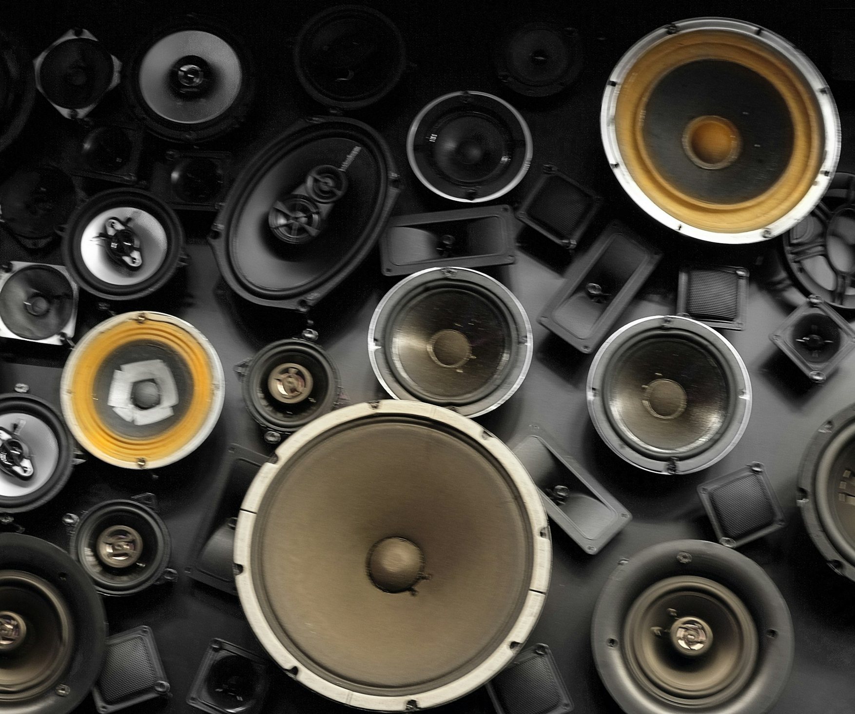 An arrangement of loudspeaker drivers and cabinets of many sizes