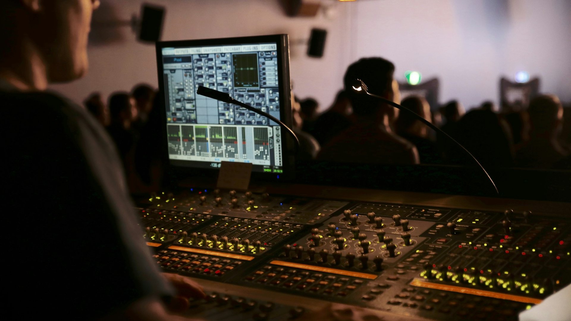 Sound engineer working at a digital mixing console during a live event